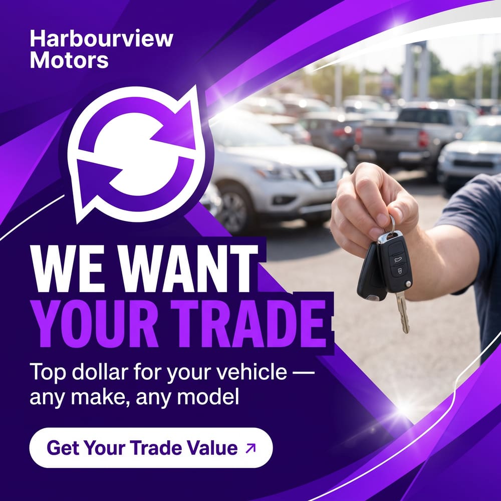 We Want Your Trade ad with a hand holding car keys in front of a used-car lot