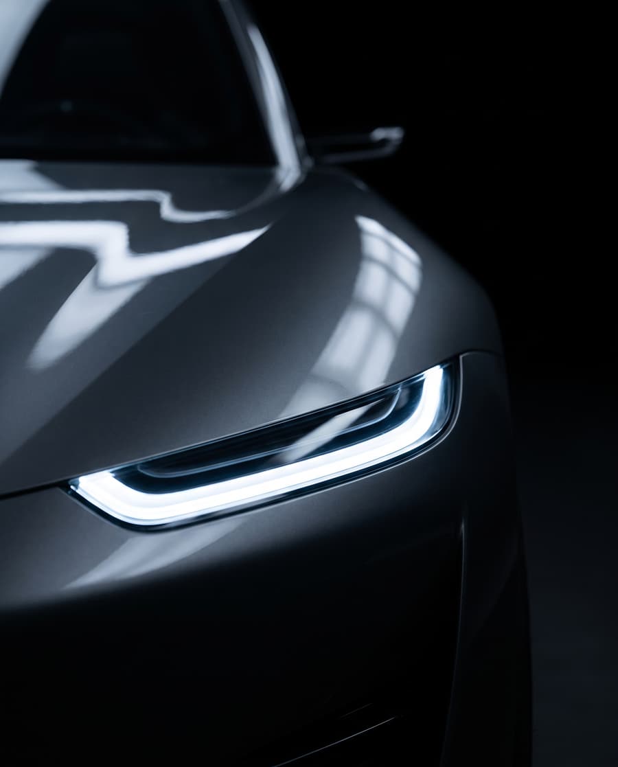 Detail of a slim LED headlight on a graphite concept car