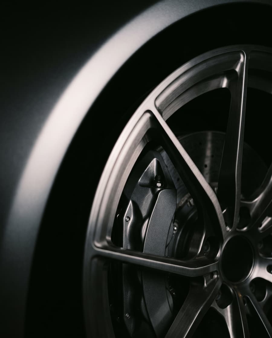 Detail of a dark alloy wheel and brake caliper